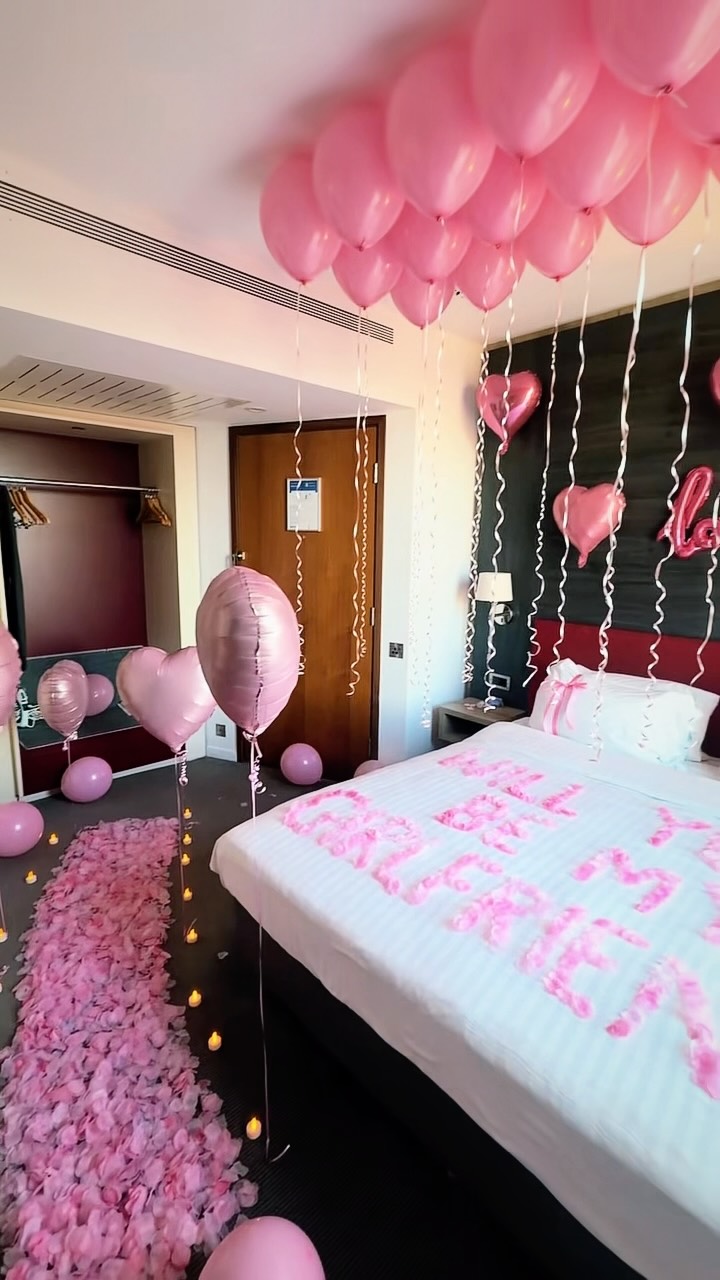 Hotel room surprise with rose petals and romantic decorations
