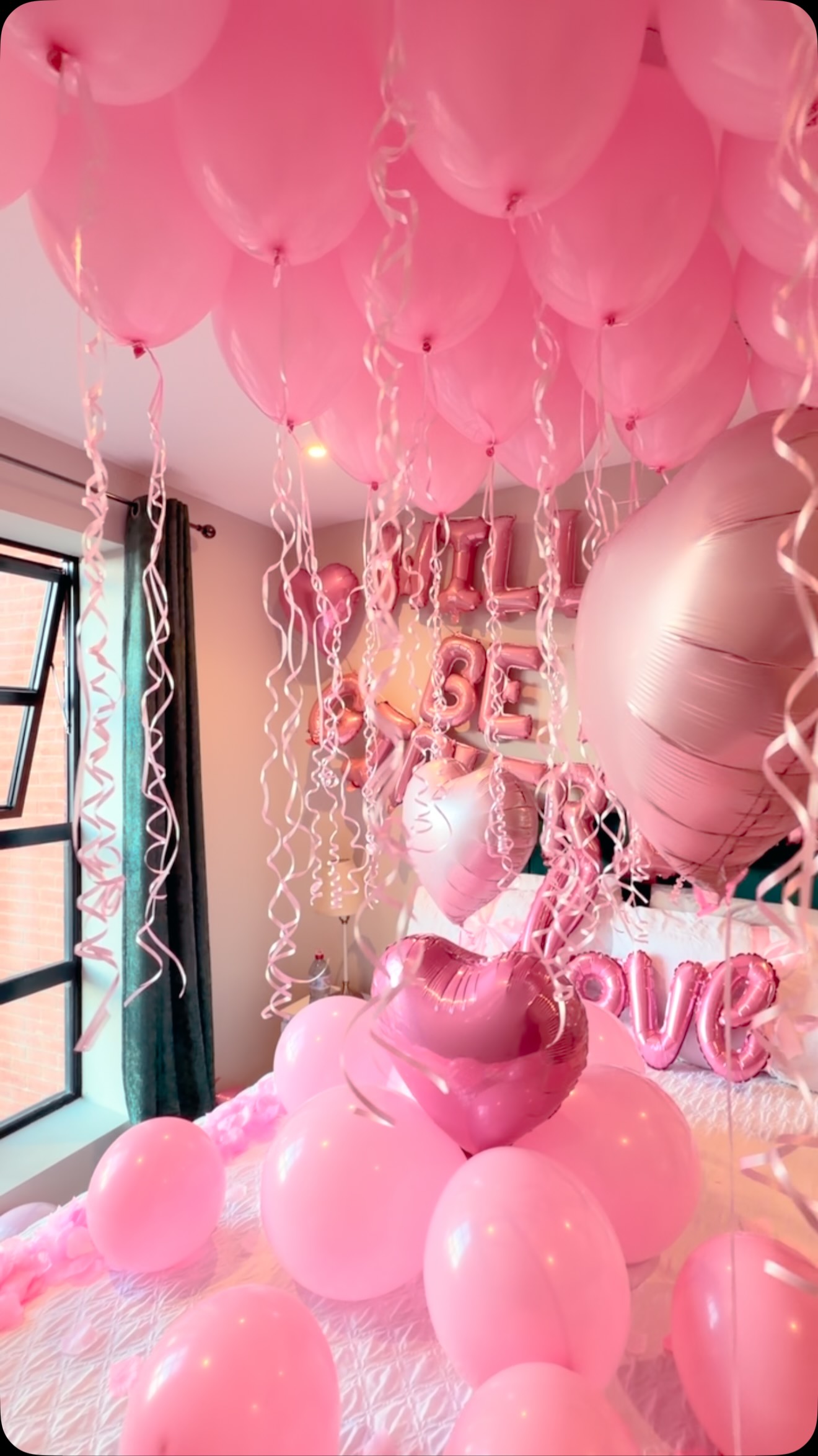 Pink balloon decorations in a celebration room
